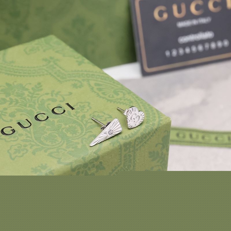 G*u*i earrings